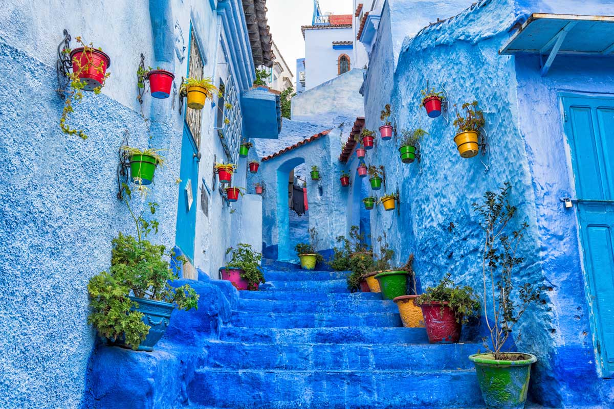 Colorful pots on the stairs of Chefchaouen Morocco