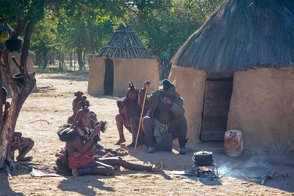 Himba tribespeople sitting around an open fire
