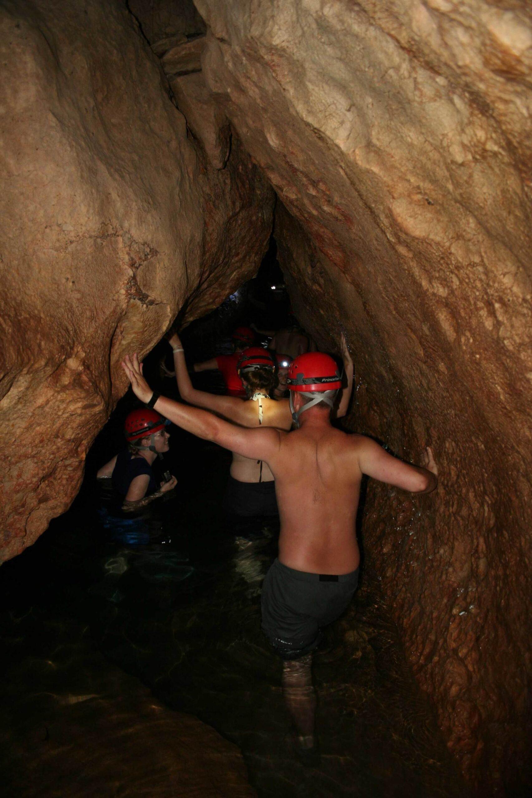 Wading through waist deep water in the cave