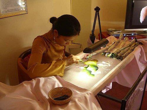 A vietnamese artist with her embroidery frame