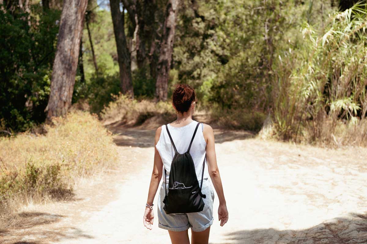 Woman hiking on dirt road