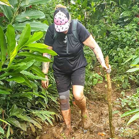 Hiking in very muddy and slippery conditions in Samoa
