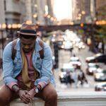 Traveler stressed and sitting on the edge of an overpass